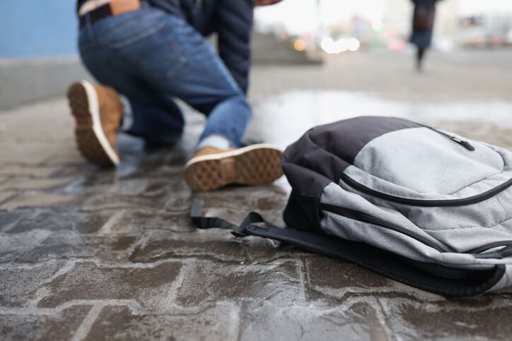 Person falling on sidewalk