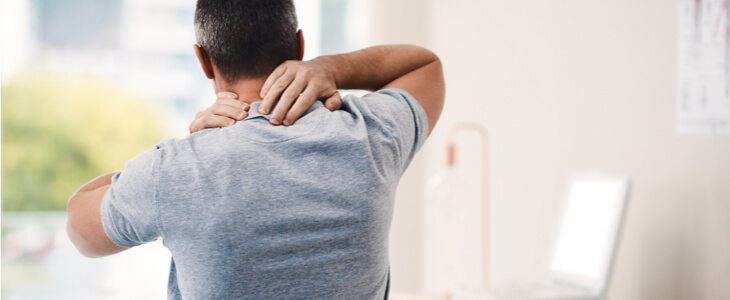 Man holding neck in pain